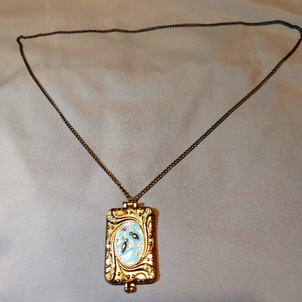 Locket with decorative bird scene